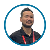 Man wearing a black shirt with a red lanyard against a white background